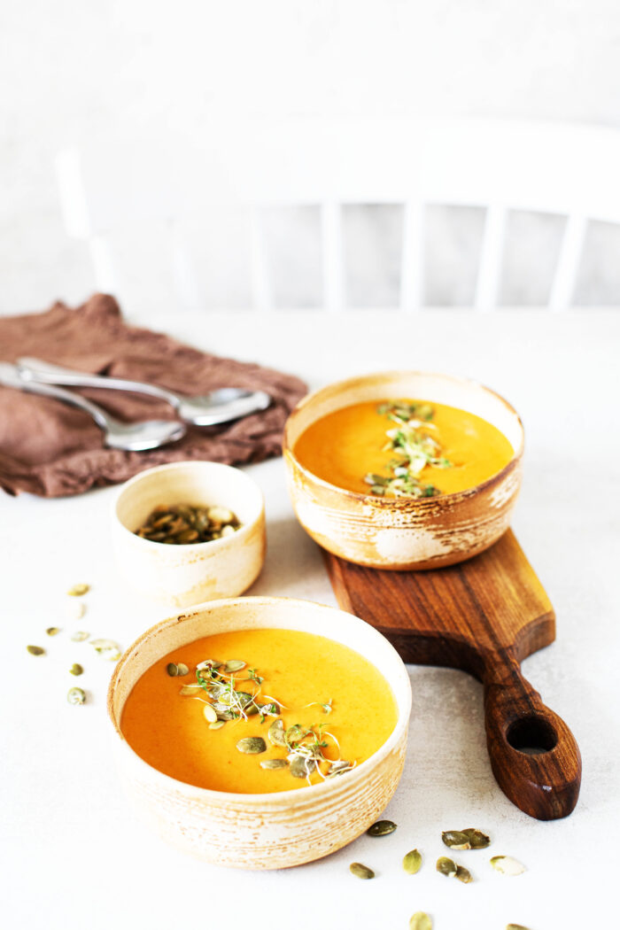 Creamy Pumpkin Soup Recipe Topped with Goat Cheese and Pumpkin Seeds!